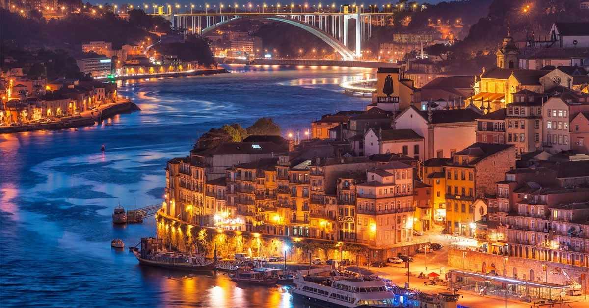 Historic Porto architecture along Douro River featuring colorful riverside buildings and traditional Portuguese aesthetic, showcasing cultural appeal for senior visitors