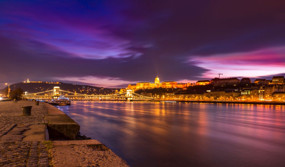 Budapest, historic destination for dental implants in Europe Night view of Budapest parliament and Danube river, dental tourism Porto vs Budapest comparison